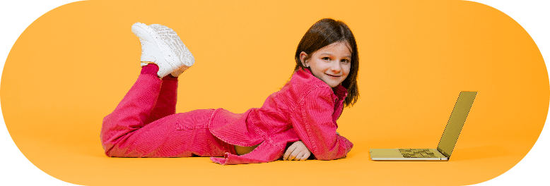 little girl laying on the floor with lap top